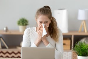 Ill,Young,Woman,Caught,Cold,Sneezing,In,Tissue,At,Home