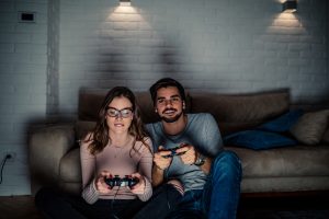 Shot,Of,Young,Couple,Playing,Video,Games,At,Home.